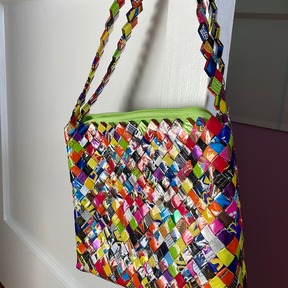 Fun label wrapper handbag. New without tags. Never used. Zipper